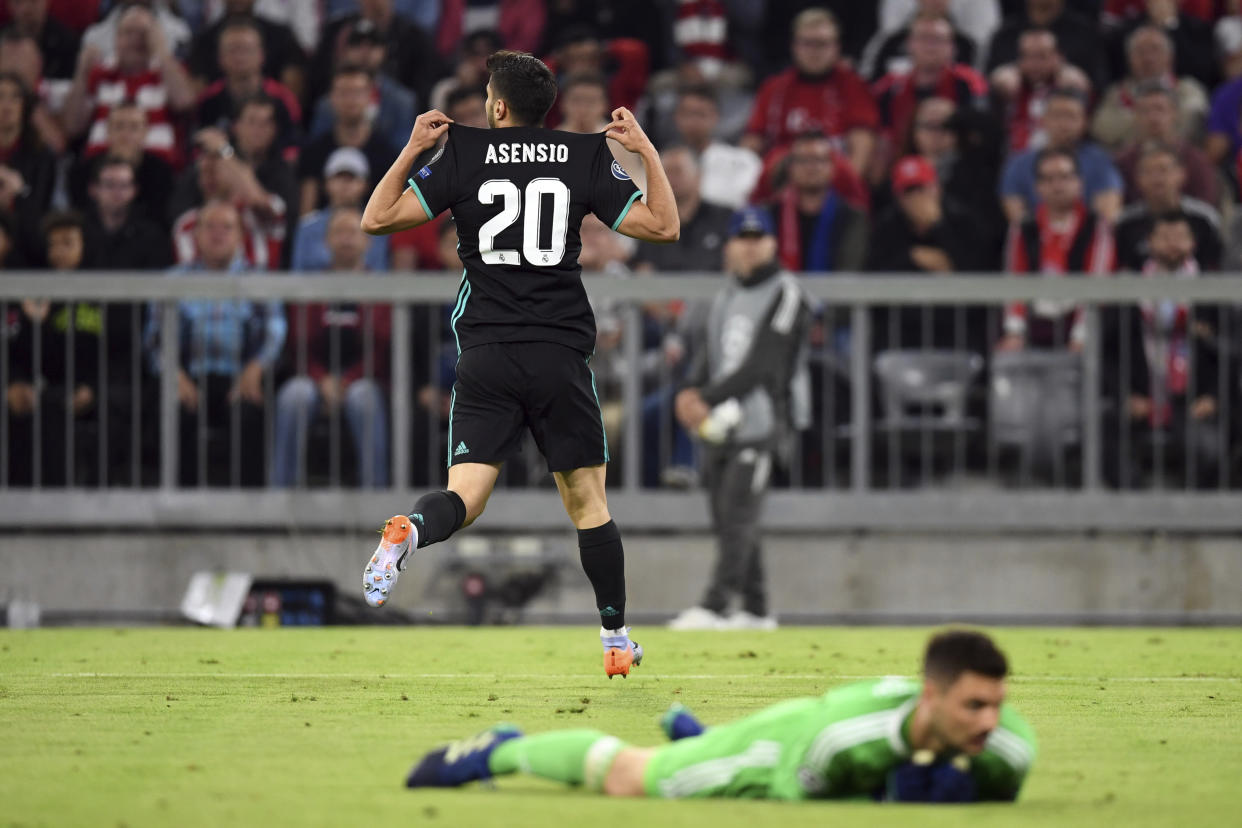 Madrid’s Marco Asensio, top, celebrates after scoring his side’s second goal during the soccer Champions League first leg semifinal soccer match between FC Bayern Munich and Real Madrid in Munich, southern Germany, Wednesday, April 25, 2018. (Andreas Gebert/dpa via AP)