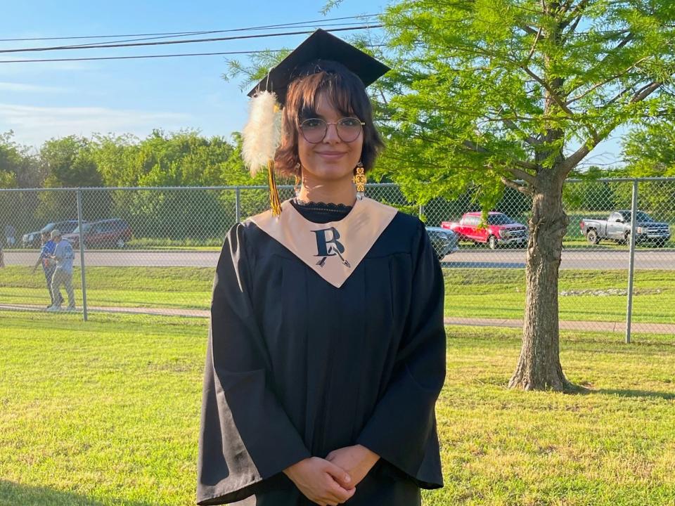 graduation photo of Lena Black wearing her eagle feather in her cap