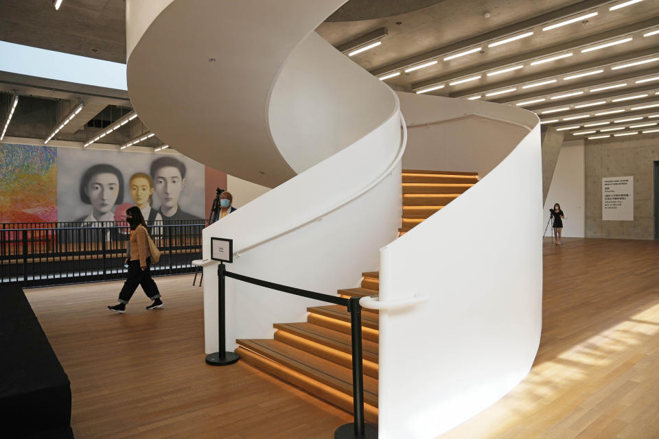 A woman walks inside the "M+" visual culture museum in the West Kowloon Cultural District of Hong Kong, Thursday, Nov. 11, 2021. Hong Kong's swanky new M+ museum _ Asia's largest gallery with a billion-dollar collection _ is set to open on Friday amid controversy over politics and censorship. (AP Photo/Kin Cheung)