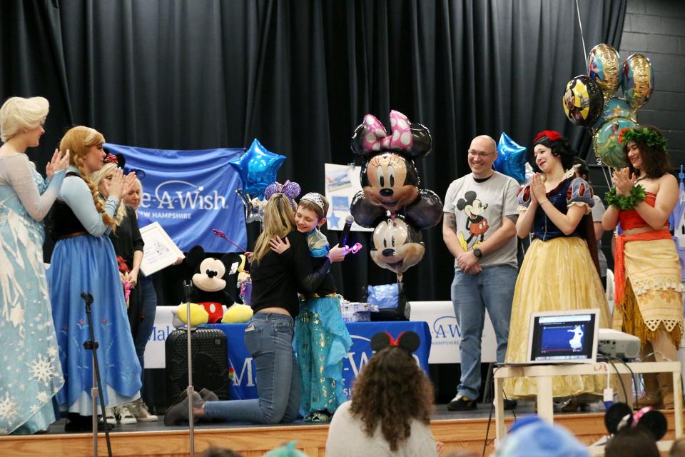 Make-A-Wish wish granter Alyssa Bailey hugs Sammy LeClair on stage after she received her Disney wish on Friday, Jan. 13, 2023 at Dondero School in Portsmouth.