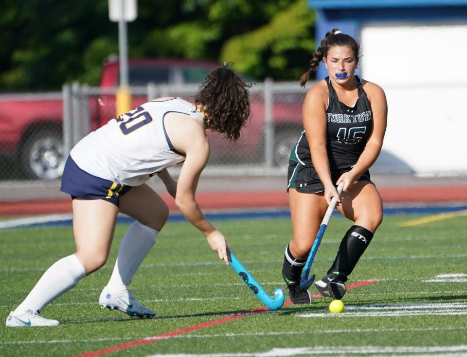 Yorktown's Katie Taormina (15) works the ball against Panas defender Kelly McAleese (20) during their 1-0 win over Panas in field hockey action at Walter Panas High School in Cortlandt on Thursday, September 21, 2023.