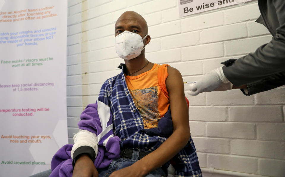 A volunteer receives an injection from a medical worker during the country's first human clinical trial for a potential vaccine against the novel coronavirus, at the Baragwanath hospital in Soweto, South Africa, June 24, 2020. REUTERS/Siphiwe Sibeko     TPX IMAGES OF THE DAY