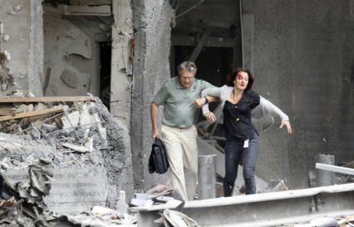 A man helps a wounded woman evacuating a building after an explosion near government buildings in Norway's capital Oslo on July 22, 2011. Anders Behring Breivik, who is set to go on trial on April 16 for killing 77 people in Norway last July -- including eight in the blast -- said in a letter published Wednesday that being sentenced to psychiatric care would be the worst fate imaginable