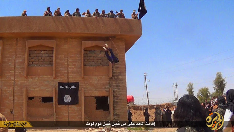 In this file photo released on Jan. 14, 2015, by a militant website, which has been verified and is consistent with other AP reporting, Islamic State militants kill a man they accused of being a homosexual by throwing him off a building in Syria's northeastern province of Hassakeh. (Militant website via AP, File)