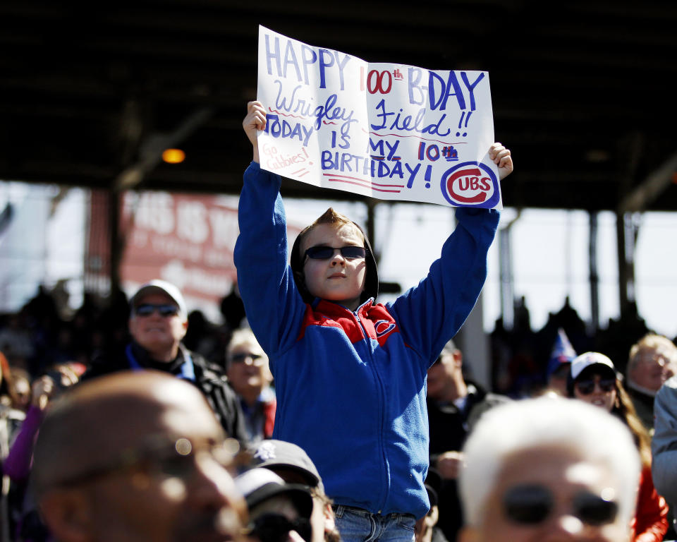 Jake Schrum, 10, of Cedar Lake, Ind., holds a sign during the fifth inning of a baseball game between the Chicago Cubs and the Arizona Diamondbacks at Wrigley Field in Chicago on Wednesday, April 23, 2014. (AP Photo/Andrew A. Nelles)