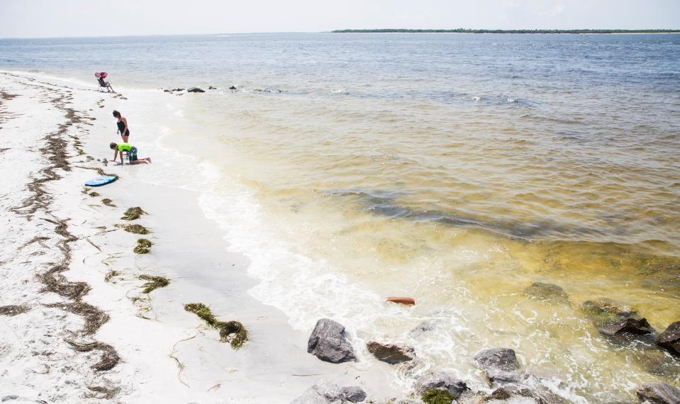 Visitors spend a morning at the Gasparilla Island State Park Boca Grande Lighthouse beach on Tuesday, July 27, 2021. Scientists have tested the waters around Boca Grande and have found low levels of red tide. 