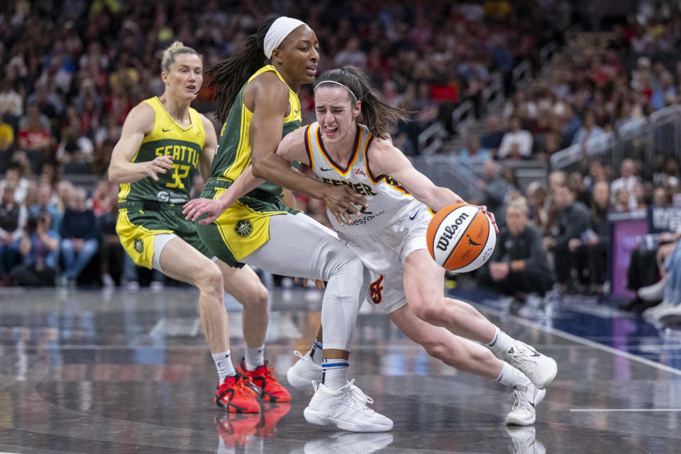 FILE - Indiana Fever guard Caitlin Clark, right, drives against Seattle Storm forward Nneka Ogwumike during the first half of a WNBA basketball game Thursday, May 30, 2024, in Indianapolis. (AP Photo/Doug McSchooler, File)