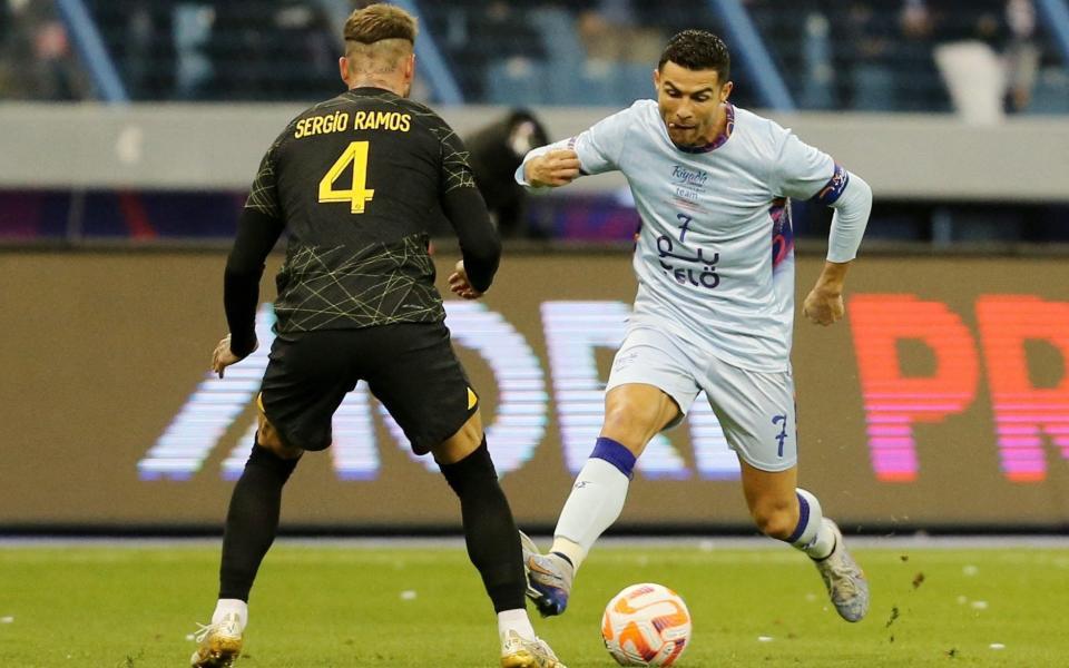 Saudi Pro League XI's Cristiano Ronaldo in action with Paris St Germain's Sergio Ramos - REUTERS