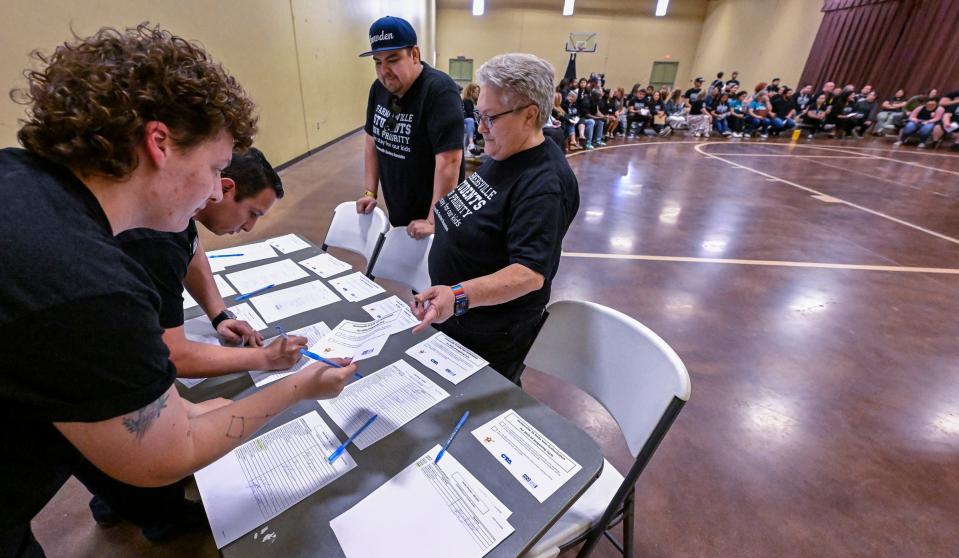 Teachers Nora Allstedt, right, and Alex Sanchez check-in Farmersville Teachers Association members Tuesday, April 16, 2024. The group voted to authorize a strike if negotiations with the district do not improve. President Richard Dybas said there was 99% support from members. There are 157 members.