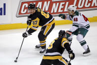 Pittsburgh Penguins' Sidney Crosby (87) looks to pass the puck as Minnesota Wild's Jared Spurgeon (46) defends during the first period of an NHL hockey game in Pittsburgh, Tuesday, Jan. 14, 2020. The Penguins won 7-2. (AP Photo/Gene J. Puskar)