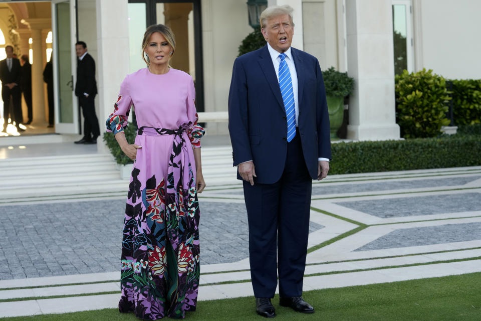 Former President Donald Trump, right, stands with Melania Trump, left, as they arrive for a GOP fundraiser, Saturday, April 6, 2024, in Palm Beach, Fla. (AP Photo/Lynne Sladky)