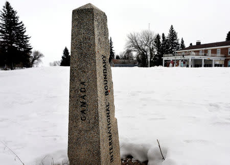 FILE PHOTO - An international boundary marker marks the Canada - U.S. border near the former border crossing at Emerson, Manitoba, Canada on February 25, 2017. REUTERS/Lyle Stafford/File Photo