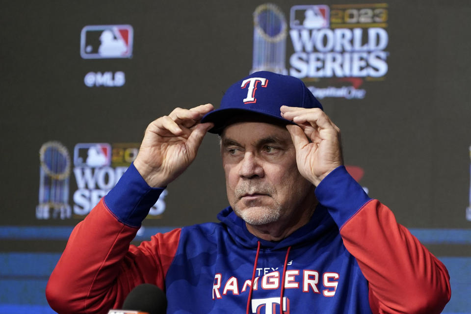 Texas Rangers manager Bruce Bochy adjusts his cap during a World Series baseball media day news conference Thursday, Oct. 26, 2023, in Arlington, Texas. The Rangers will play the Arizona Diamondbacks in Game 1 of the World Series tomorrow. (AP Photo/Tony Gutierrez)