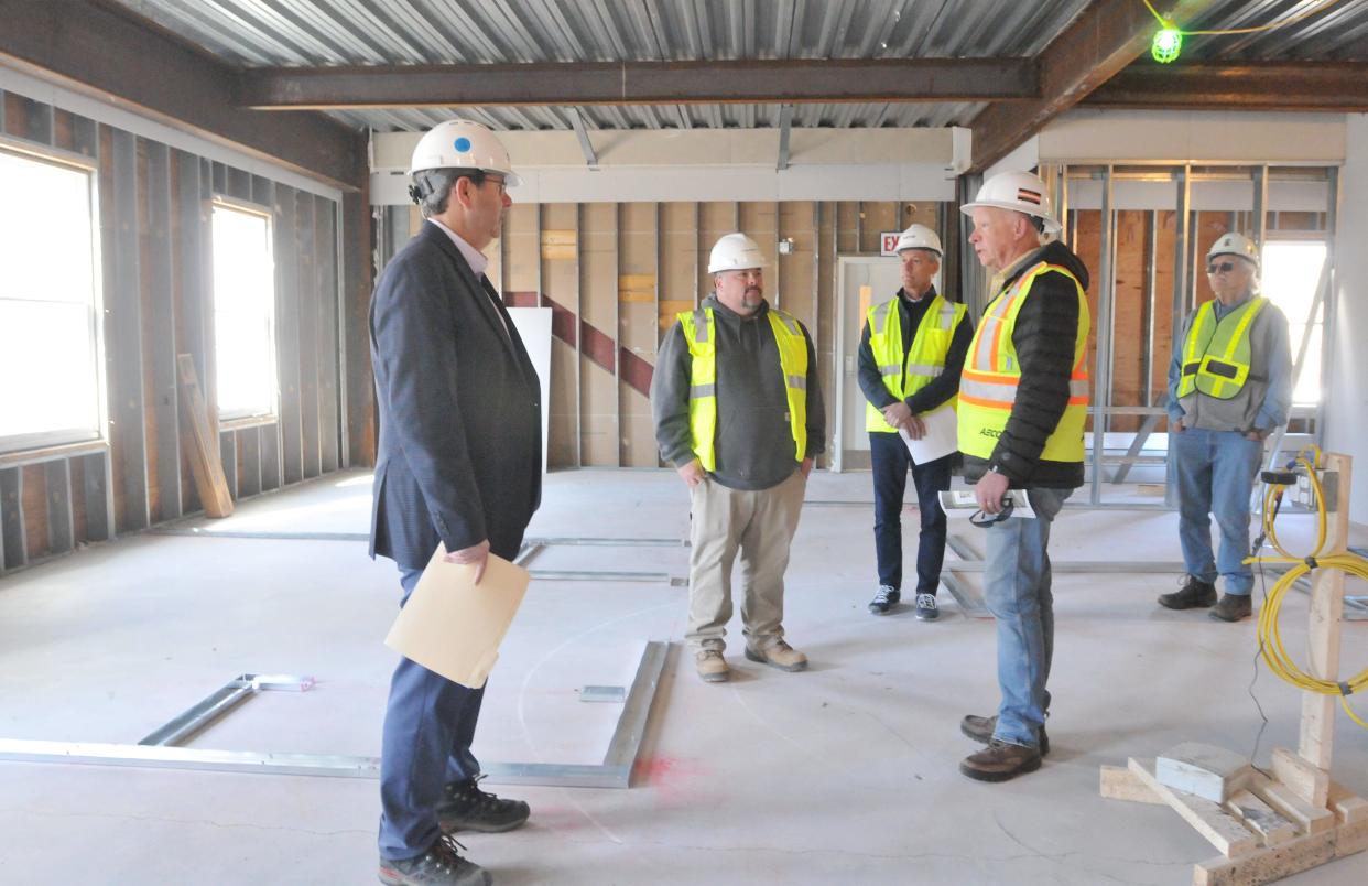 On the third floor, project manager Jeff Guilherme, second from left, talks about the progress of the new multi-family housing project. He was leading a site visit with Pennrose regional vice president Charlie Adams, left, select board chair Michael Herman, center, select board member Kevin Galligan and affordable housing trust chair Alan McClennen, right. 
Developer Pennrose is renovating the former Cape Cod 5 operations center on West Road into multi-family rental units.