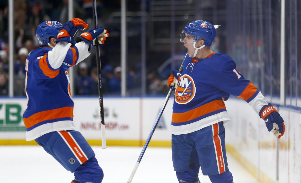 New York Islanders center Bo Horvat, right, celebrates after his winning goal with teammate Noah Dobson, left, during the overtime period of an NHL hockey game against the Toronto Maple Leafs, Monday, Dec. 11, 2023, in New York. (AP Photo/John Munson)