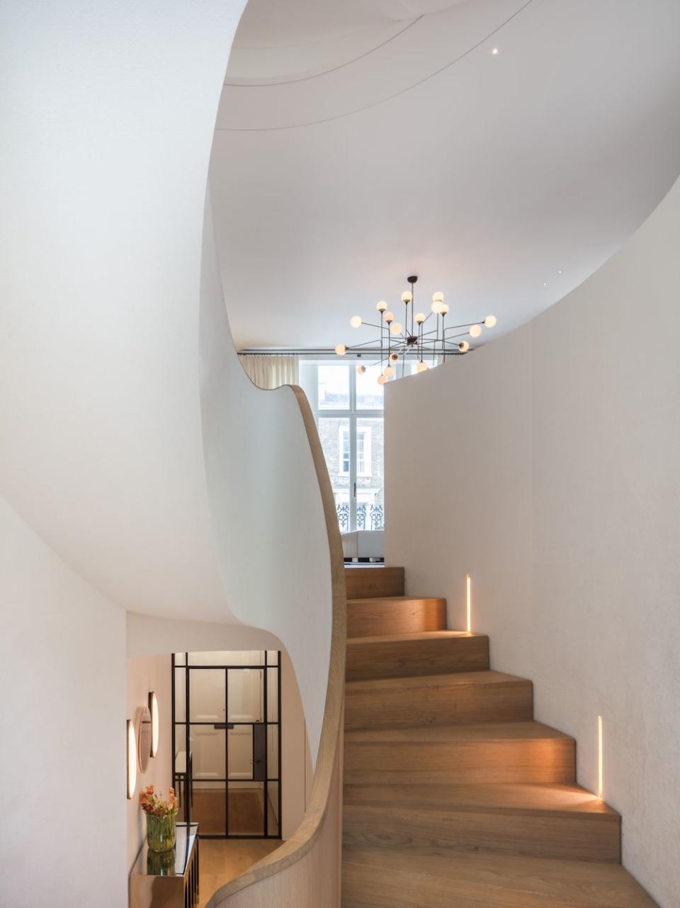 white staircase with lights built into the wall