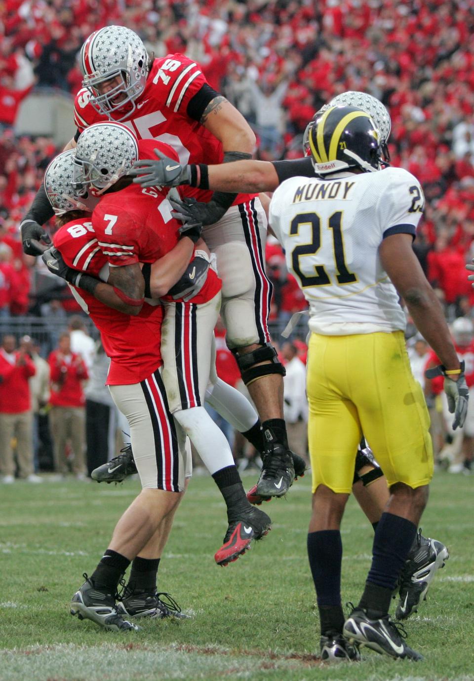 Ohio State's Rory Nicol (88) lifts Ted Ginn Jr. (7) as Alex Boone (75), join in to celebrate Ginn's 2006 touchdown against Michigan.