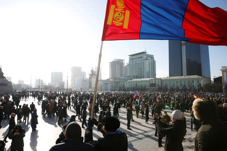 A protester waves a Mongolian flag during a demonstration to demand the resignation of Mongolia's parliamentary speaker Enkhbold Miyegombo, at Sukhbaatar Square in Ulaanbaatar, Mongolia December 27, 2018. REUTERS/B. Rentsendorj