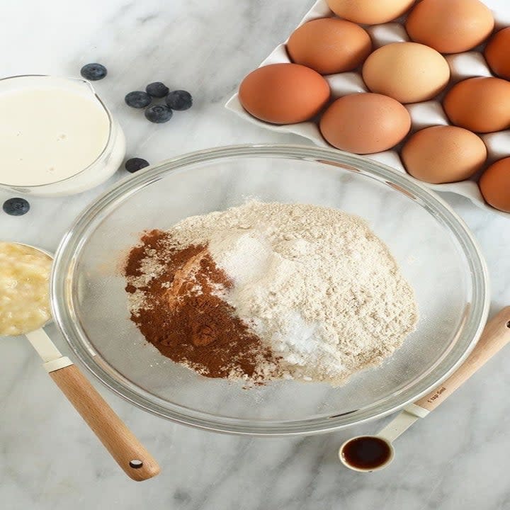 Ingredients for pancakes in a mixing bowl.