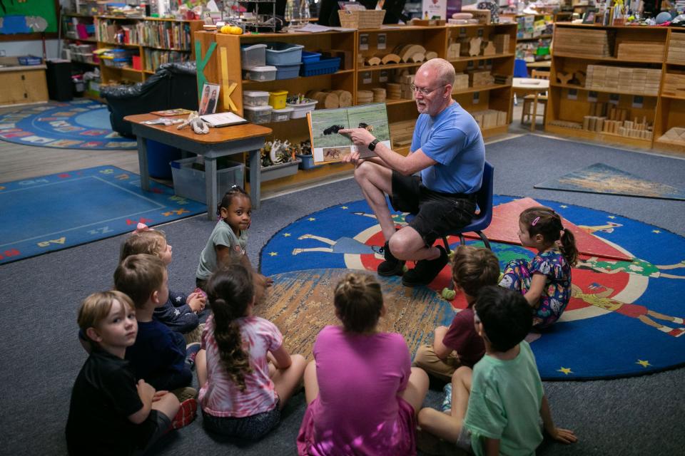 Chuck Alexander reads a book to children at Creative Preschool on Tuesday, April 25, 2023. 