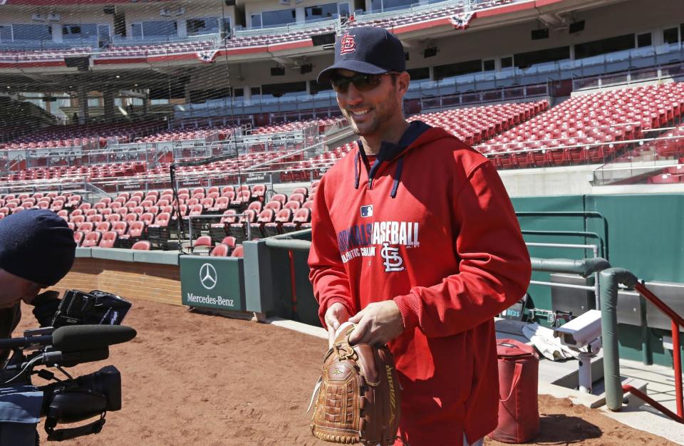 St. Louis Cardinals starting pitcher Adam Wainwright walks onto the field at the start of batting practice on Sunday, March 30, 2014, in Cincinnati. Wainwright will be the starting pitcher for the Cardinals in Monday's Opening Day baseball game against the Cincinnati Reds in Cincinnati. (AP Photo/Al Behrman)