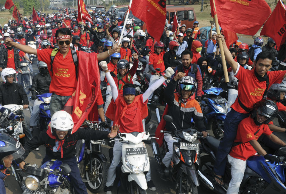 Factory workers take part in a protest in Cikarang, West Java, Indonesia, Wednesday, Oct. 3, 2012. Indonesian unions said more than 2 million factory workers have gone on a one-day strike across the country to call for higher wages and protest the hiring of contract workers. (AP Photo)