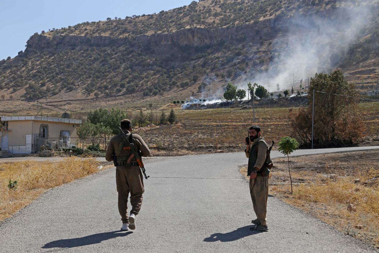 Kurdish fighters walk to inspect the damage following an Iranian cross-border attack in the area of Zargwez, where several exiled left-wing Iranian Kurdish parties maintain offices, near the Iraqi city of Sulaimaniyeh, September 28, 2022. / Credit: AFP via Getty