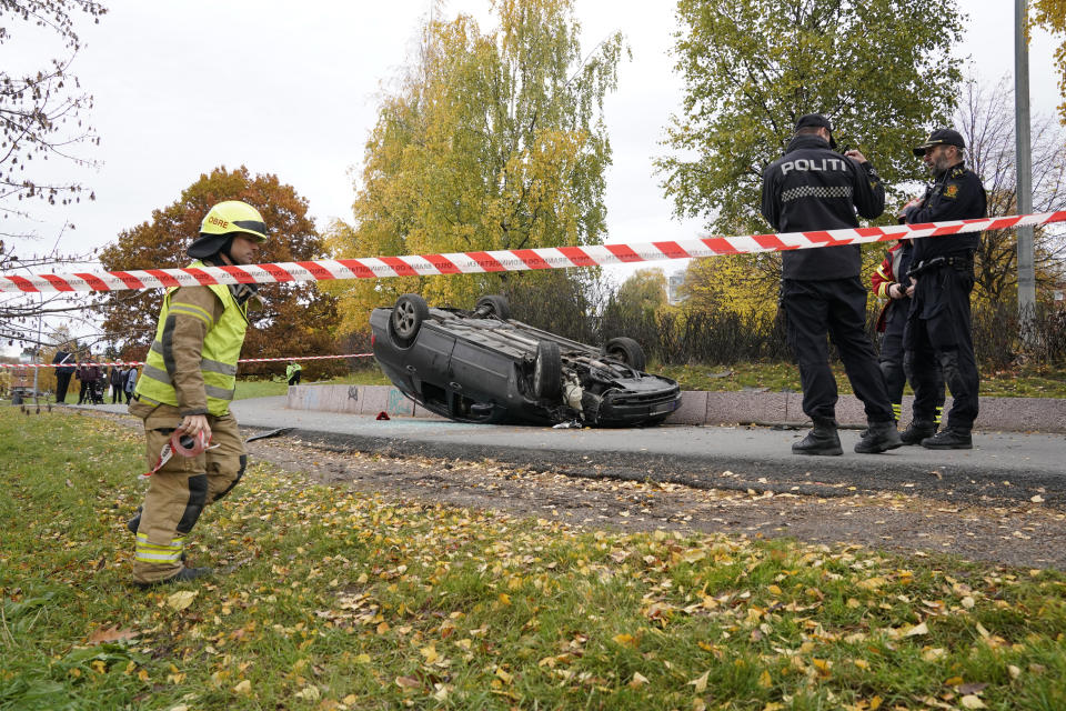 An upturned car is cordoned off by police after an incident in the center of Oslo, Tuesday, Oct. 22, 2019. Norwegian police opened fire on an armed man who stole an ambulance in Oslo and reportedly ran down several people. (Stian Lysberg Solum/NTB scanpix via AP)
