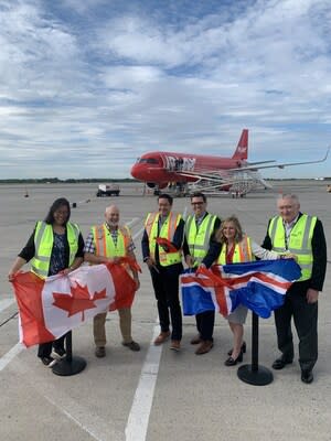 Hamilton city councillors Tammy Hwang (far left), and Mark Tadeson (second left) joins PLAY airlines’ CEO Birgir Jónsson (middle left), Cole Horncastle, executive managing director, John C. Munro Hamilton International Airport (middle right), Cathie Puckering, vice president and head, Canadian Network Vantage Airport Group (right) and Ed Minich, board of director, Hamilton International Airport (far right) to cut the ribbon introducing the inaugural flight to Canadian travellers. (CNW Group/PLAY)