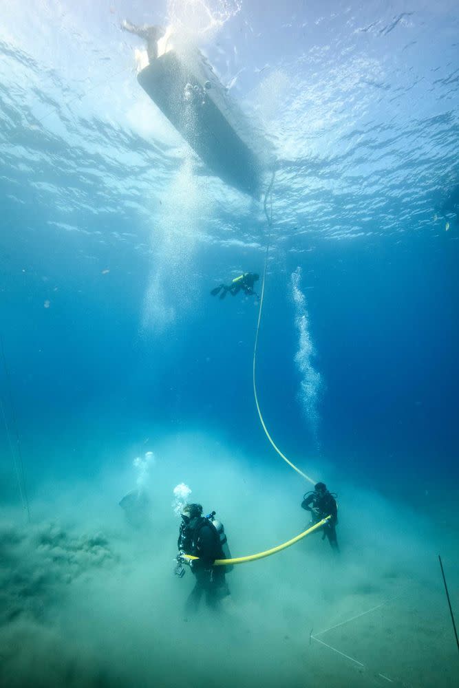 Dive teams investigate one of the many anomalies discovered during the magnetometer survey of the waters thought to contain the remains of Hernán Cortés' scuttled fleet of 1519. In the 500 years since the event, a lot of sand has moved into the area covering the location of these archaeological sites. This sand must be carefully removed to reveal pieces of the fleet buried beneath it. On the right of the frame is a white string delineating the search area | Courtesy of Jonathan Kingston