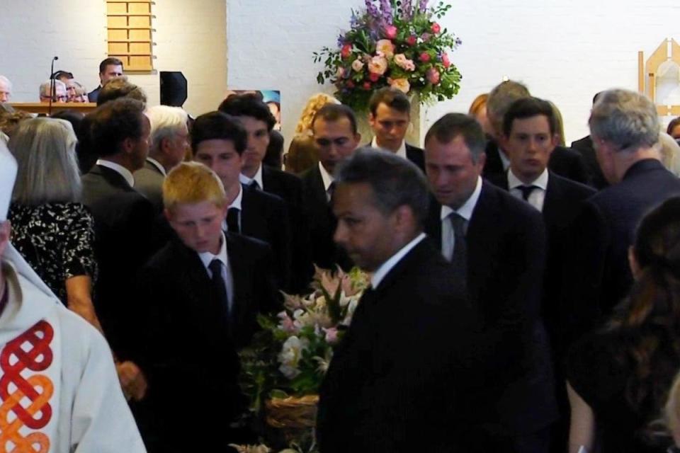 Iris' brother Frankie, and centre right, her father Ben, carry her coffin