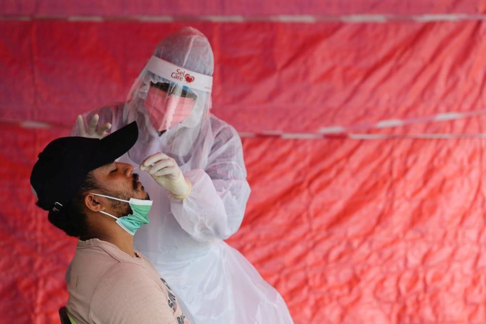 Health workers collect swab samples to test for Covid-19 at the Selcare Clinic in Shah Alam August 1, 2021. — Picture by Yusof Mat Isa