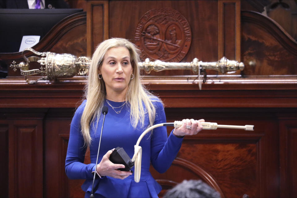 South Carolina state Rep. Beth Bernstein, D-Columbia, holds a transvaginal ultrasound wand on the second day of debate over a bill banning most abortions when cardiac activity is detected, generally around six weeks and often before women know they're pregnant, on Wednesday, May 17, 2023, in Columbia, S.C. (AP Photo/James Pollard)