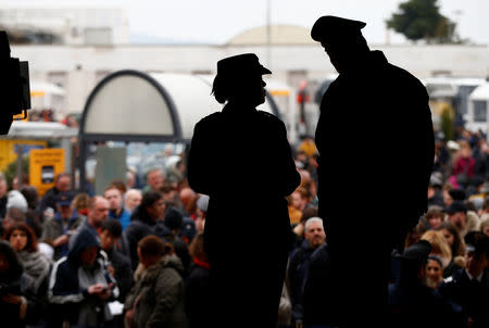 Police watch passengers who were evacuated due to a fire at Ciampino Airport in Rome, Italy, February 19, 2019 gather outside the teminal building. REUTERS/Yara Nardi