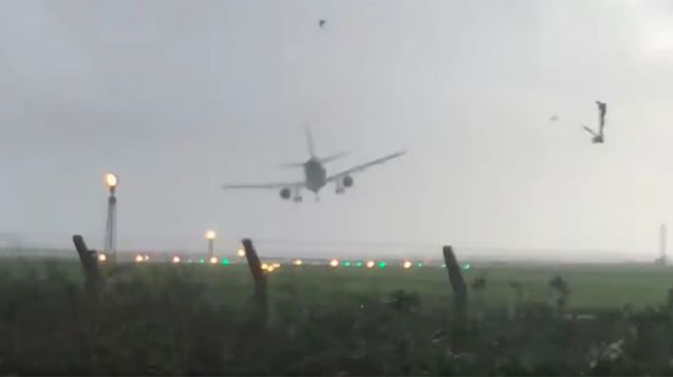 Struggling to maintain balance, the plane is thrown by one final gust just seconds before its wheels hit the tarmac. Source: Storyful