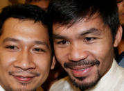 Philippine boxing star and Senator Manny Pacquiao (R) poses with a supporter after he was declared by elections officials as one of the 12 new members of the upper house of Congress in Manila, Philippines May 19, 2016. REUTERS/Erik De Castro