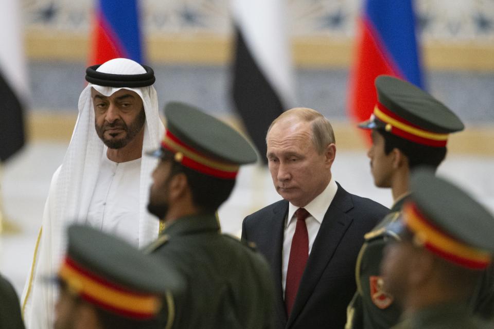 Russian President Vladimir Putin, right, and Abu Dhabi Crown Prince Mohamed bin Zayed al-Nahyan, left, attend the official welcome ceremony in Abu Dhabi, United Arab Emirates, Tuesday, Oct. 15, 2019. (AP Photo/Alexander Zemlianichenko, Pool)