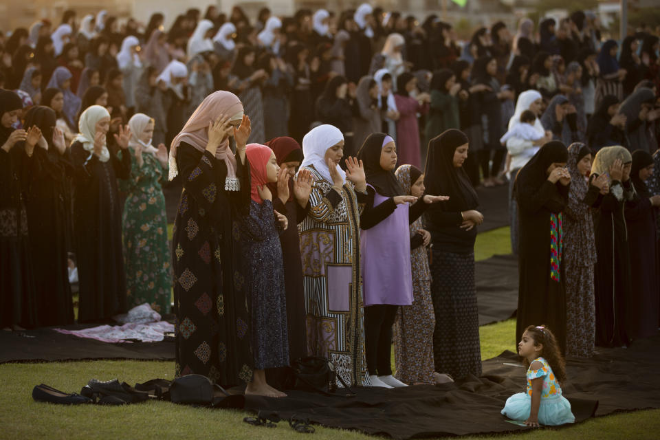 Muslim worshippers offer Eid al-Adha prayer in the mixed Arab Jewish city of Jaffa, near Tel Aviv, Israel, Tuesday, July 20, 2021. The major Muslim holiday, at the end of the hajj pilgrimage to Mecca, is observed around the world by believers and commemorates prophet Abraham's pledge to sacrifice his son as an act of obedience to God. (AP Photo/Oded Balilty)