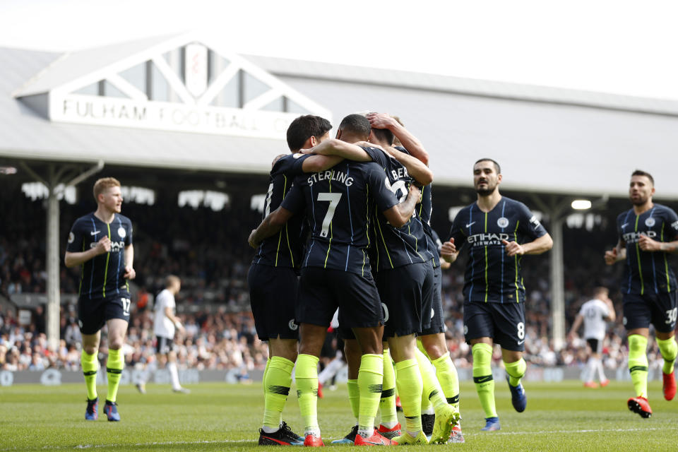 Manchester City players celebrate after Bernardo Silva scored the opening goal during the English Premier League soccer match between Fulham and Manchester City at Craven Cottage stadium in London, Saturday, March 30, 2019. (AP Photo/Alastair Grant)