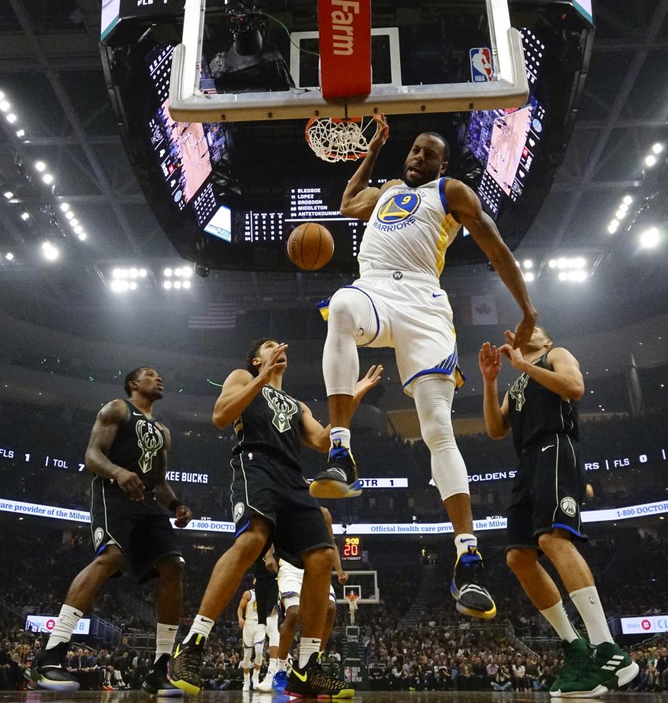 The Warriors’ Andre Iguodala dunks against the Milwaukee Bucks on Friday night in Milwaukee. (AP Photo/Morry Gash)