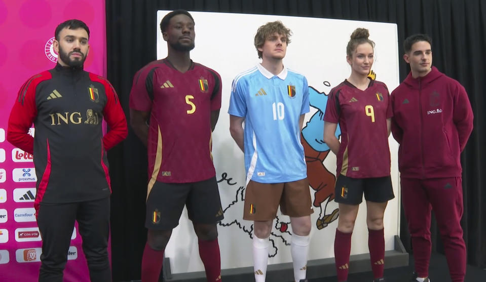 In this grab made from video, models wearing Belgium jerseys pose during the unveiling of the new Belgium soccer national team jersey, in Brussels, Belgium, Thursday, March 14, 2024. (SNTV via AP)