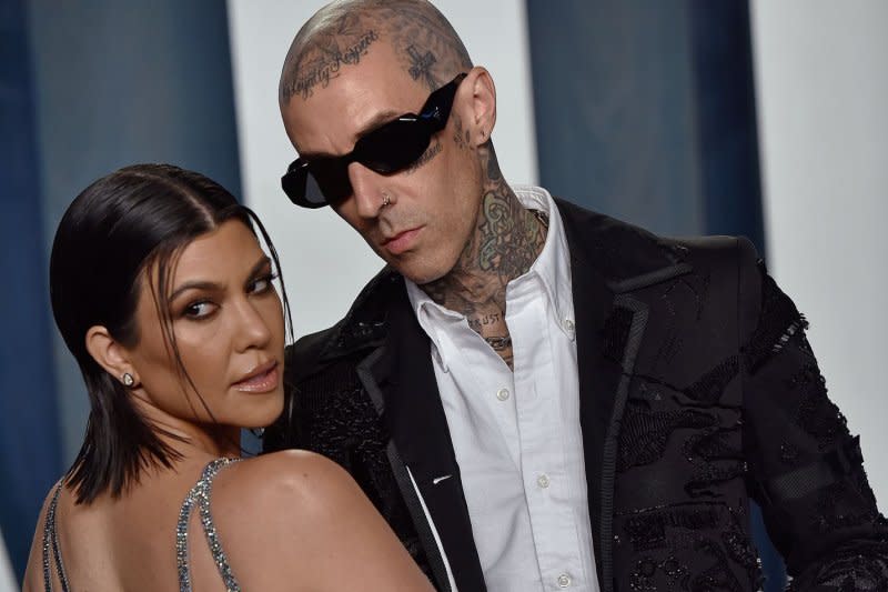 Kourtney Kardashian (L) and her fiance Travis Barker arrive for the Vanity Fair Oscar Party at the Wallis Annenberg Center for the Performing Arts in Beverly Hills, Calif., in 2022. File Photo by Chris Chew/UPI