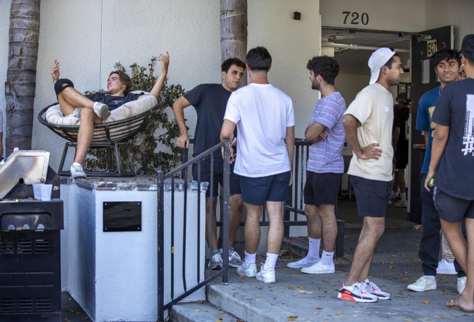 USC students talk in front of fraternity house.