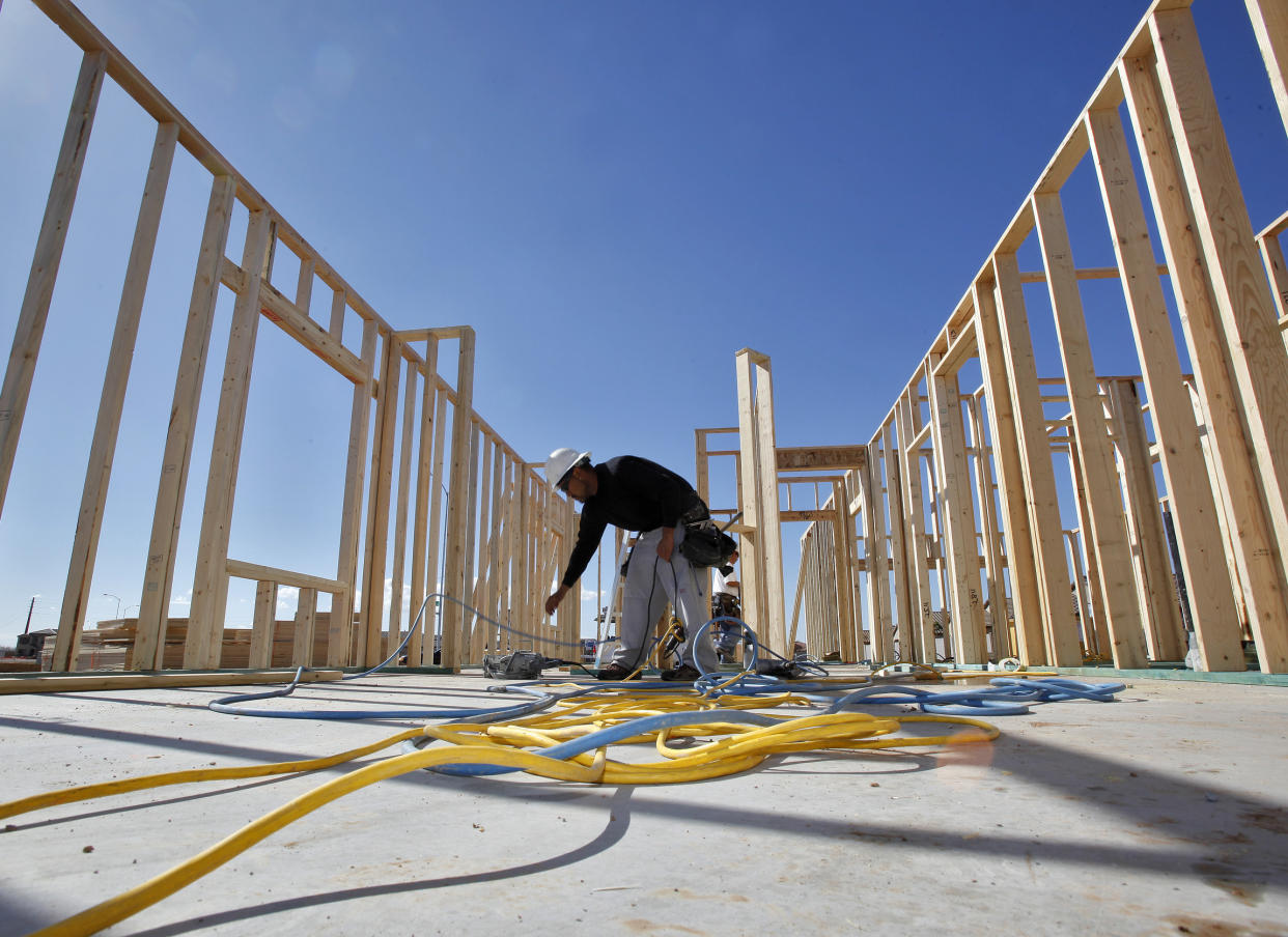 The file photo, workers construct new Pulte homes in Mesa, Ariz. PulteGroup, Inc. reports earnings Tuesday, Oct. 24, 2017. (AP Photo/Matt York, File)