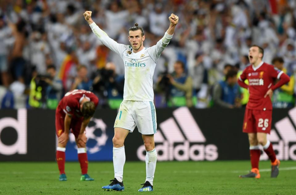 <p>Gareth Bale raises his arms aloft after netting Real Madrid’s third</p>