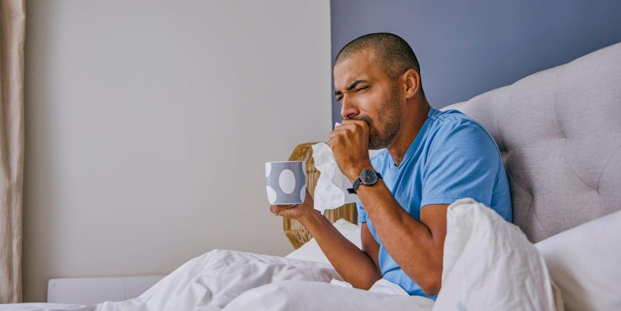 shot of a young man suffering from a cold at home