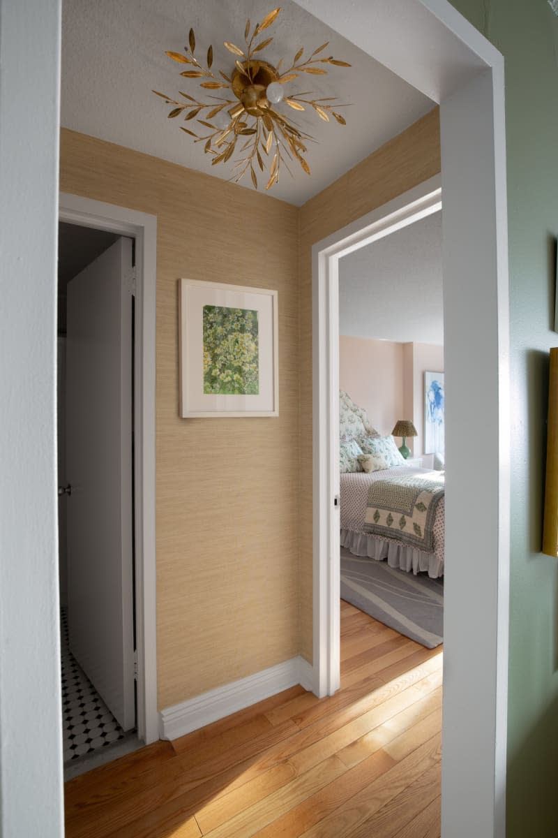 Hallway with multiple door ways and vintage sun lighting fixture