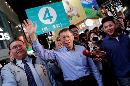 Ko Wen-je, Taipei mayor who is seeking for a re-election, waves to supporters ahead of the upcoming local elections, in Taipei