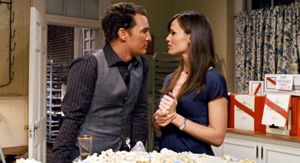 Matthew McConaughey and Jennifer Garner stand close, engaged in a tense discussion in a kitchen setting