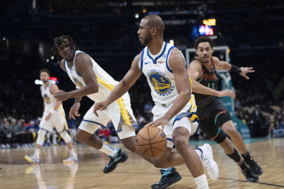 Golden State Warriors guard Chris Paul (3) dribbles the ball while Washington Wizards guard Jordan Poole, right, runs to defend during the first half of an NBA basketball game in Washington, Tuesday, Feb. 27, 2024. (AP Photo/Manuel Balce Ceneta)